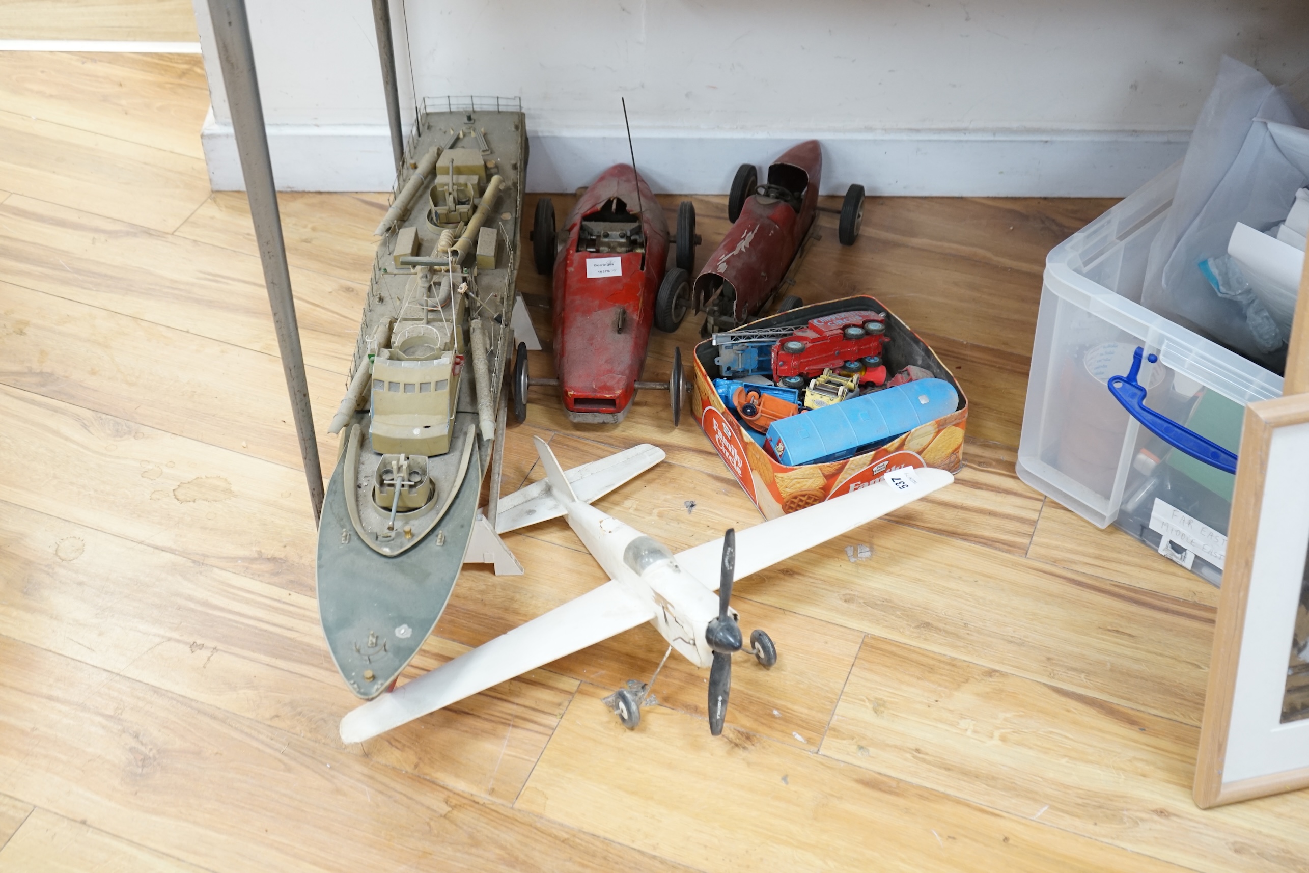 Two tinplate model racing cars, a model aeroplane, battleship and other various cars. Condition - poor